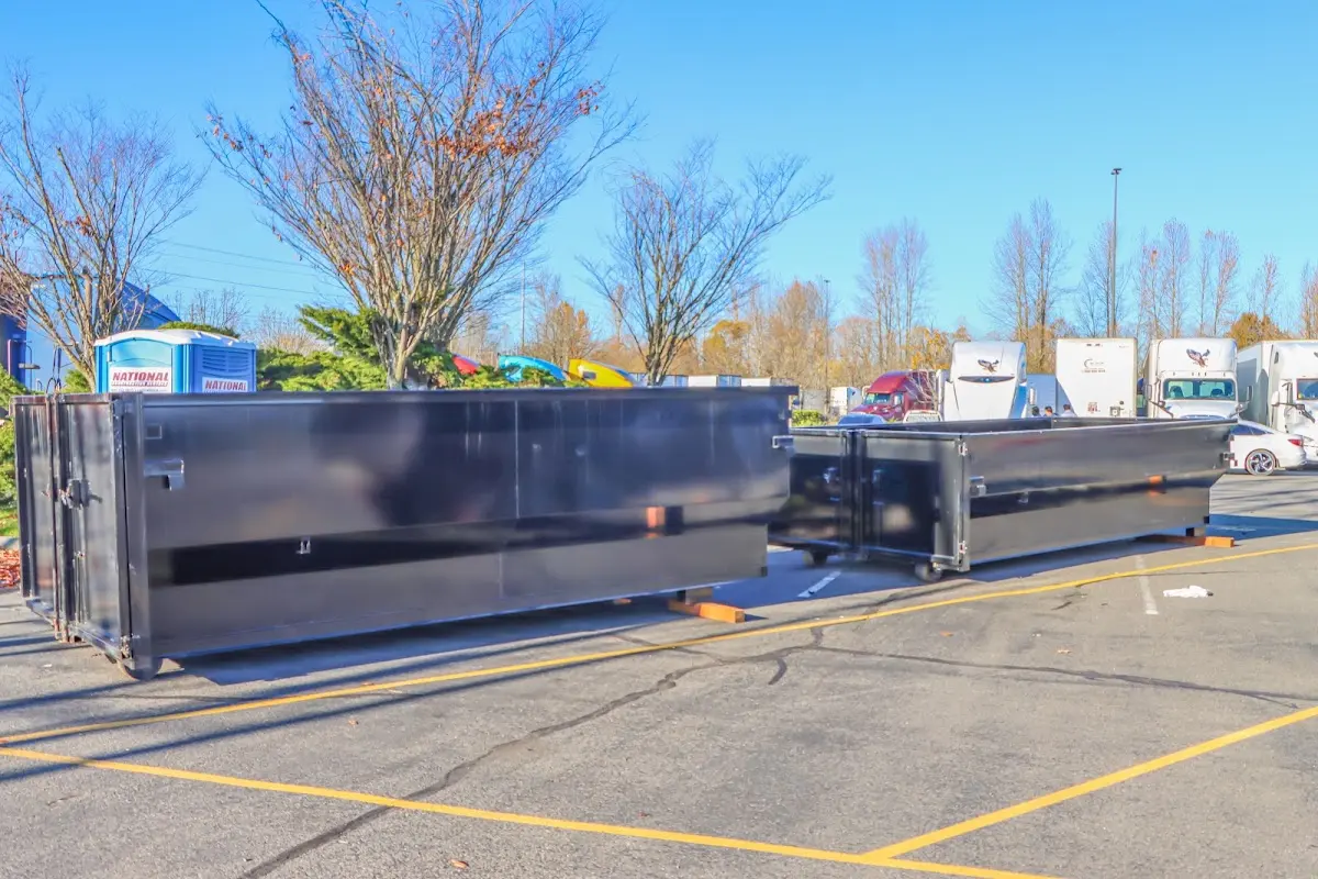 Professional dumpster rental service with roll-off container on residential driveway in Dunwoody